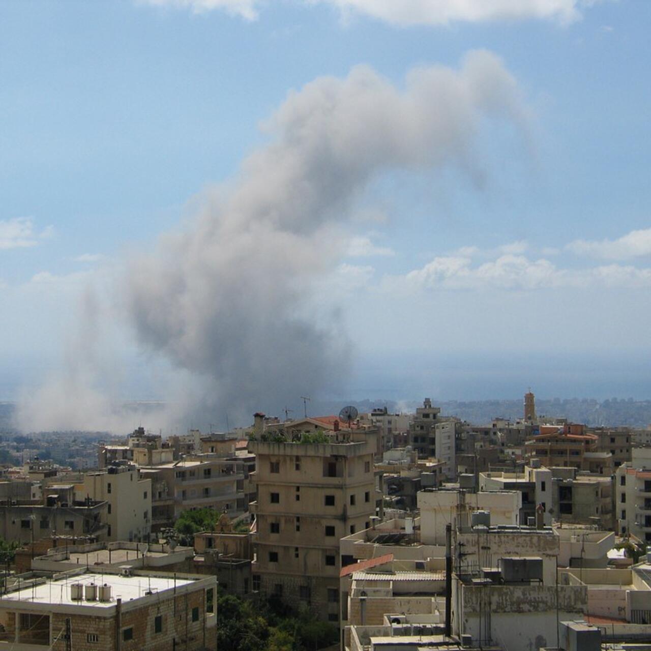 The skyline of Beirut with a huge plume of smoke in the background.