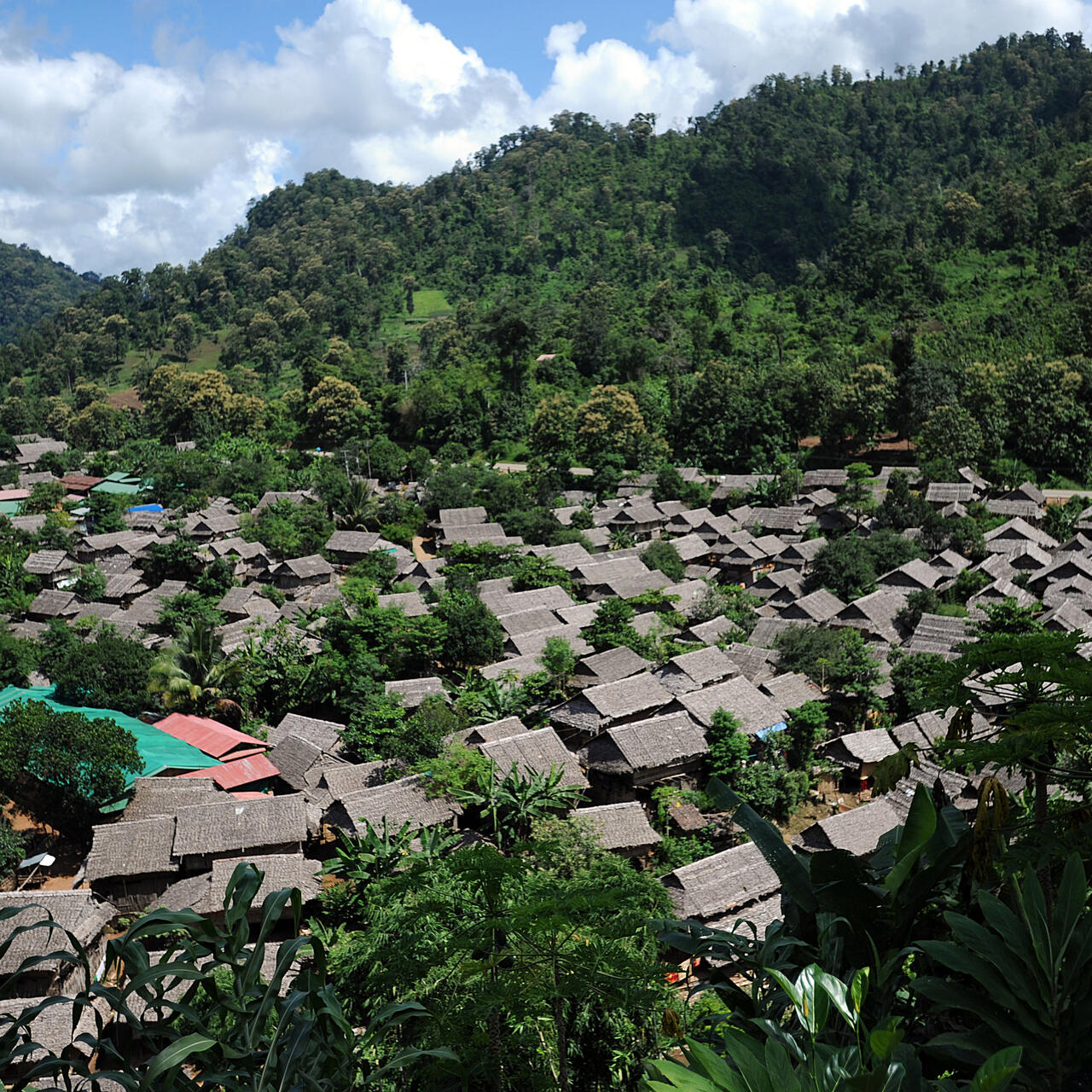 An aerial view of Mae La refugee camp, nestled within jungle-covered hills in Thailand