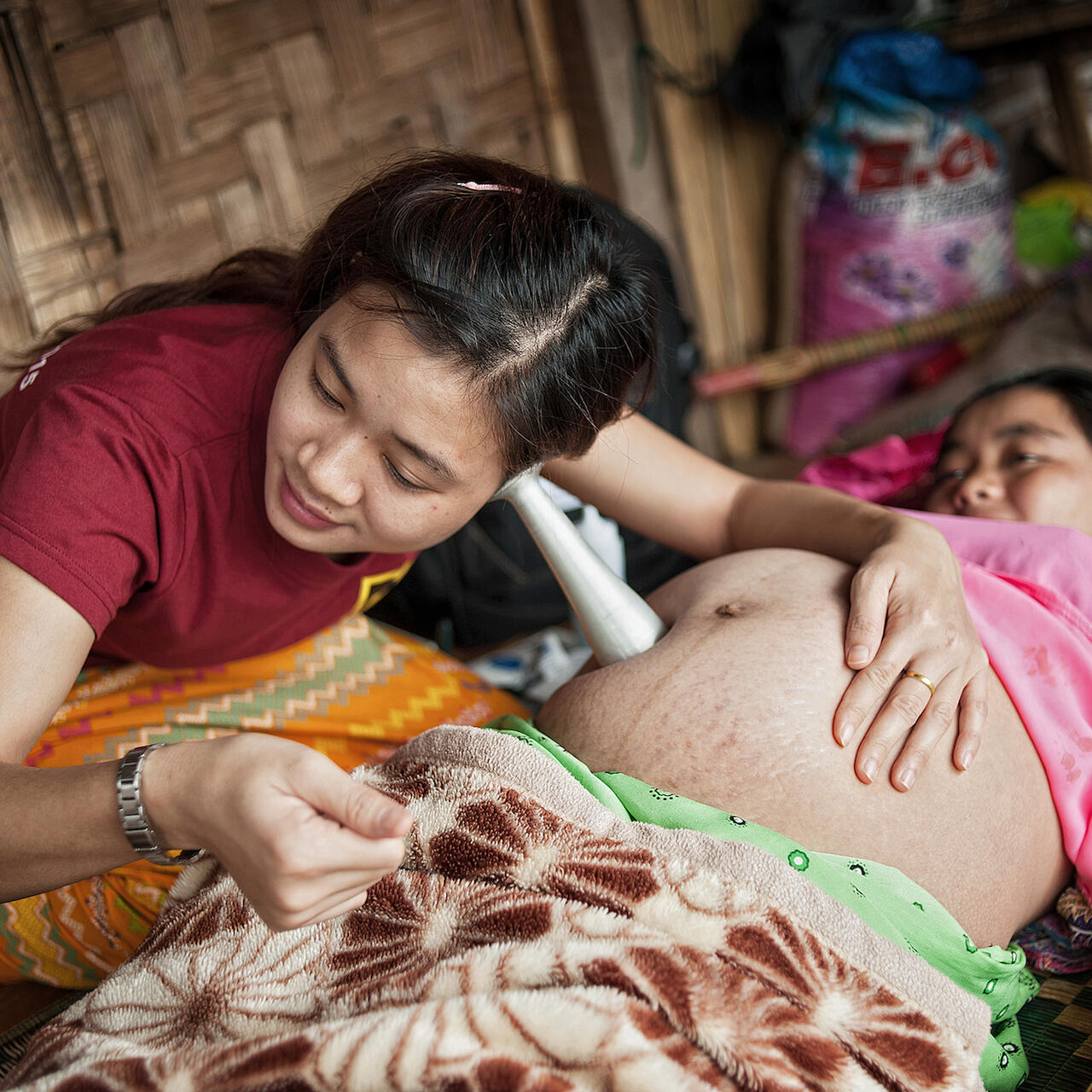 A mobile clinic nurse visits Ma J Nan at home