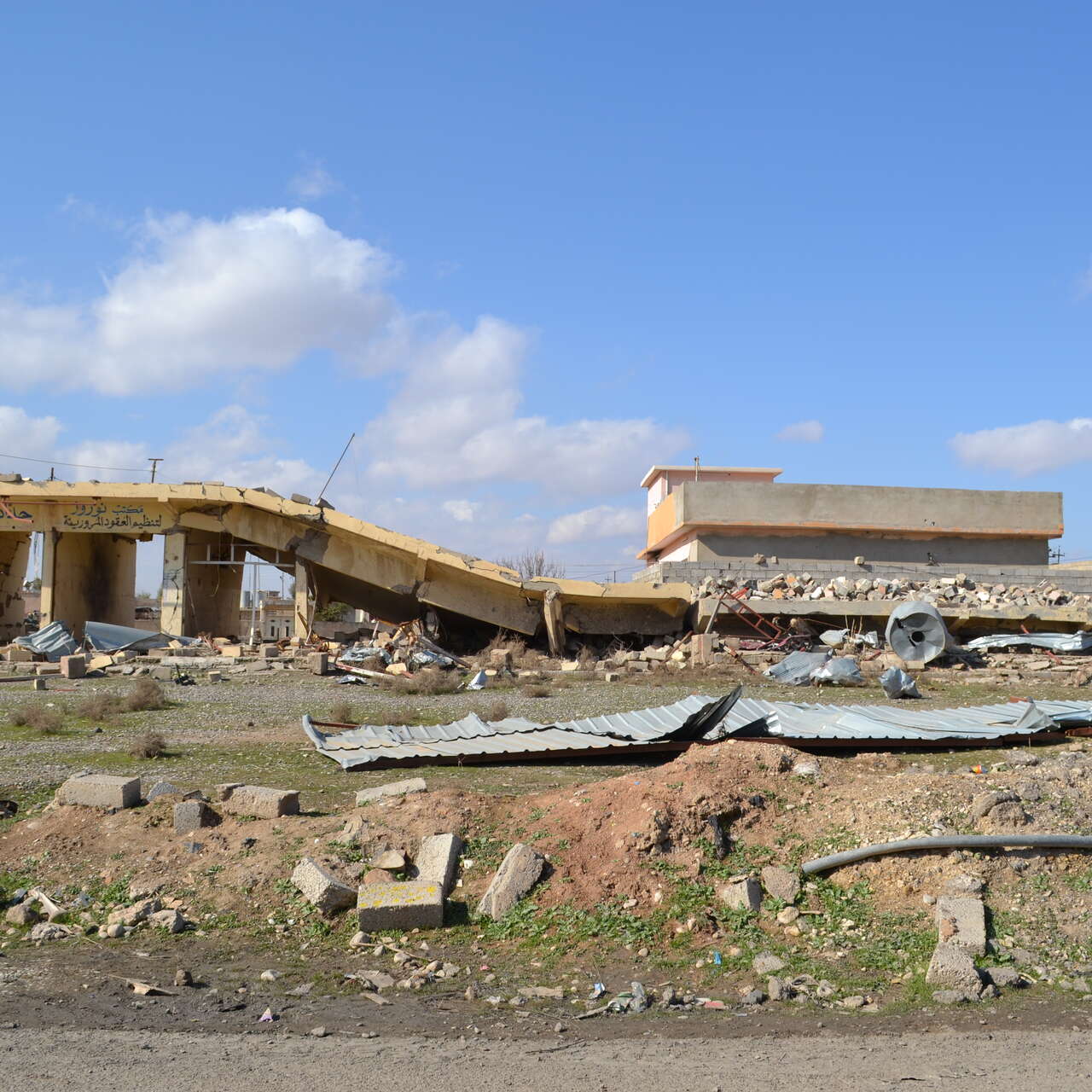 A collapsed row of shops, severely damaged by heavy fighting to retake the village of Baybokht from ISIS towards the beginning of battle for Mosul 