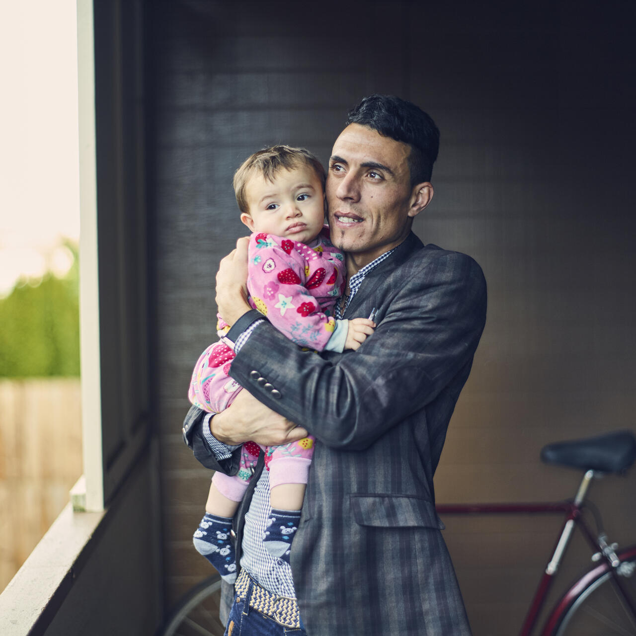 Adil with his son Steven outside their apartment