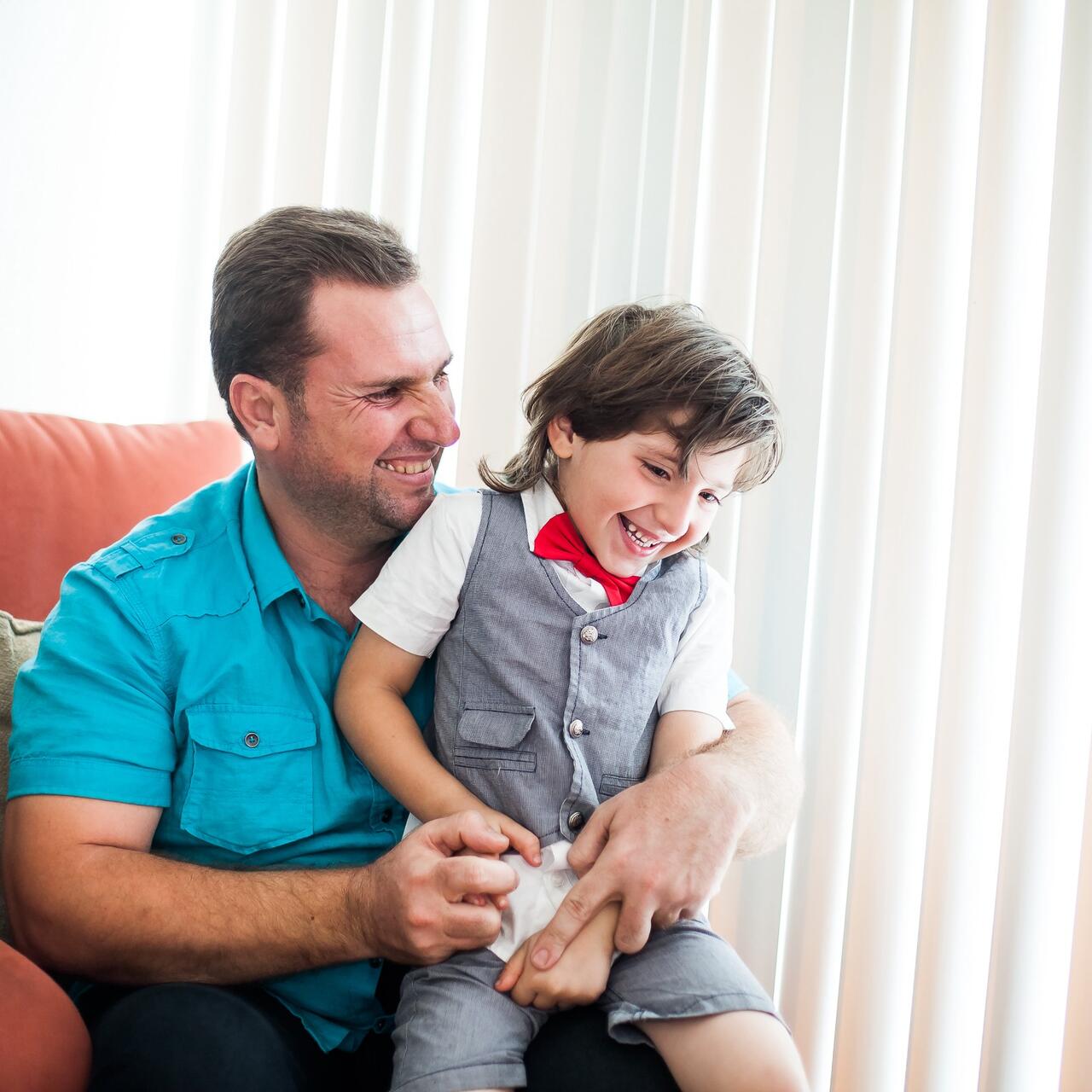 Hamzah sits with his his five-year-old son Abdullah in their Oakland, California home.