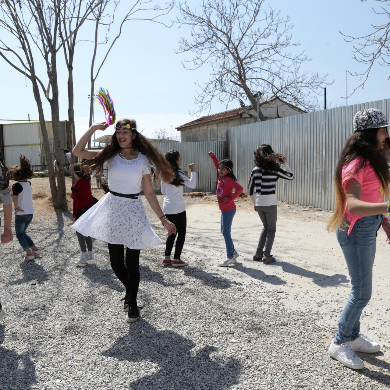 Girls dance at an IRC safe healing and learning space in Eleaonas refugee camp in Greece.