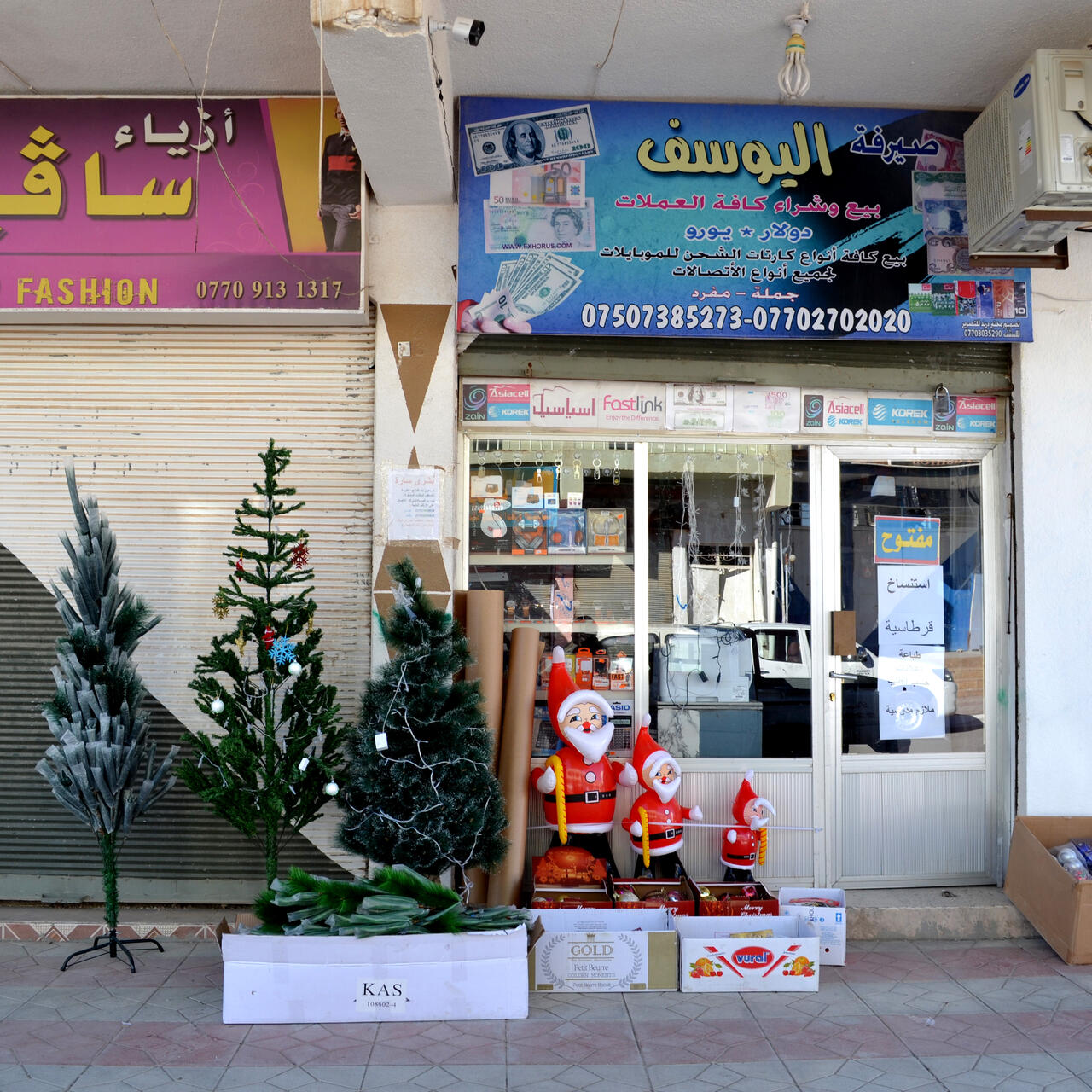 Christmas trees and Santa decorations displayed for sale outside a shop in northern Iraq