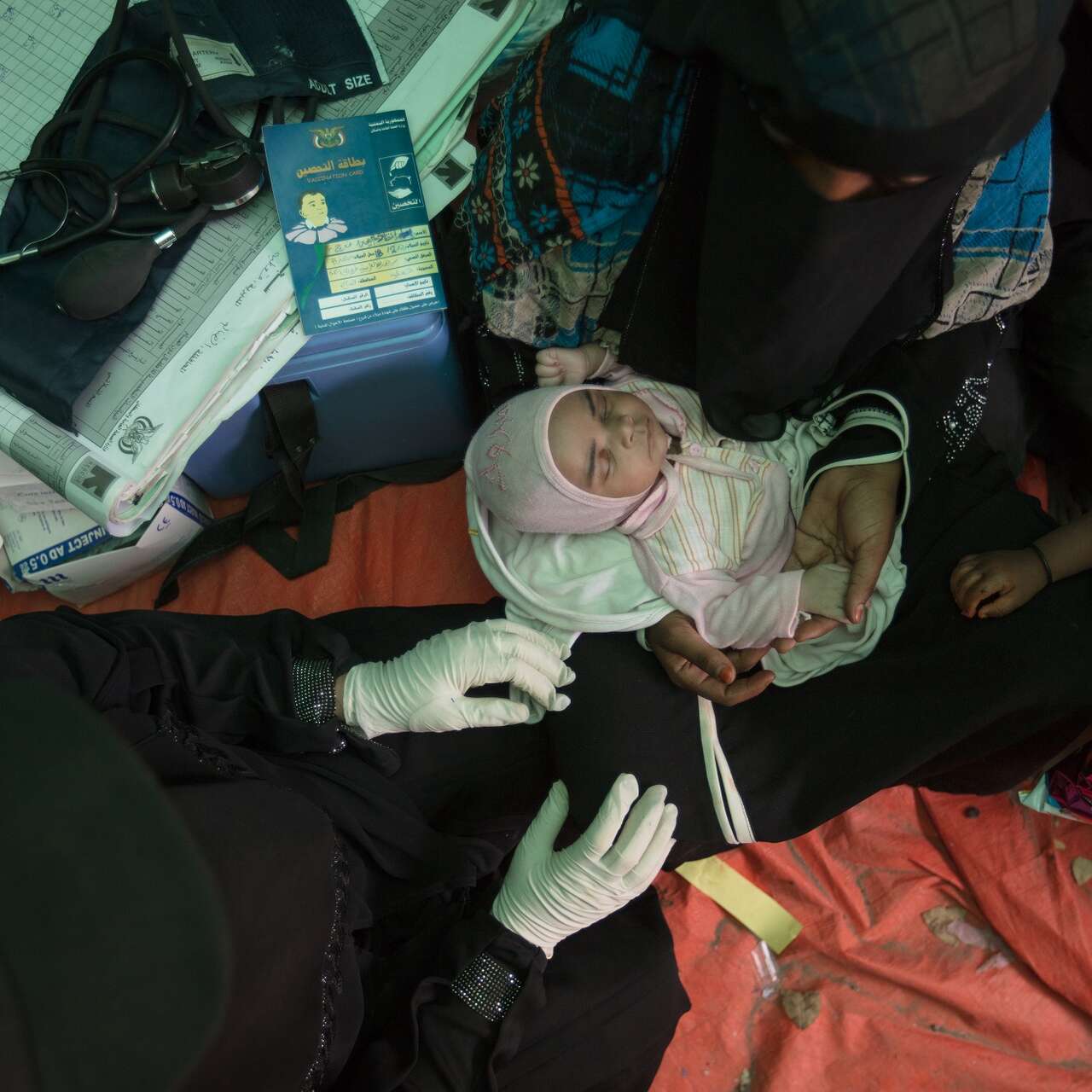 Baby Enkath receiving a check-up from IRC midwife Samya.