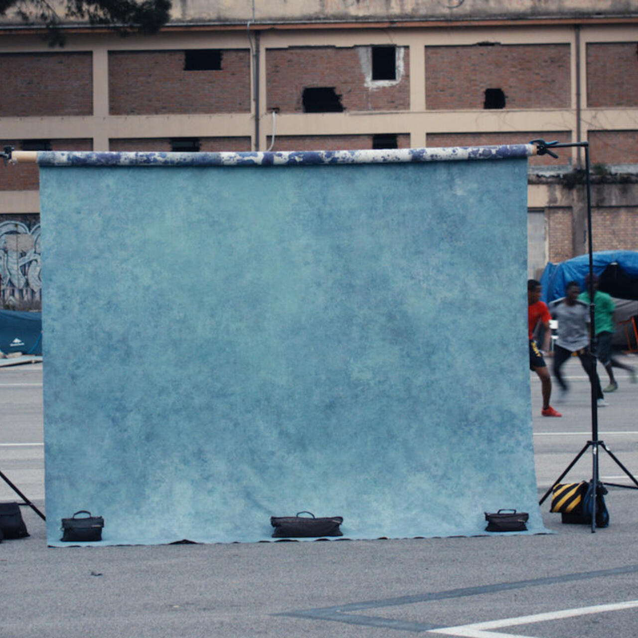 A photographer's backdrop ready for a shoot at a makeshift refugee settlement in Italy