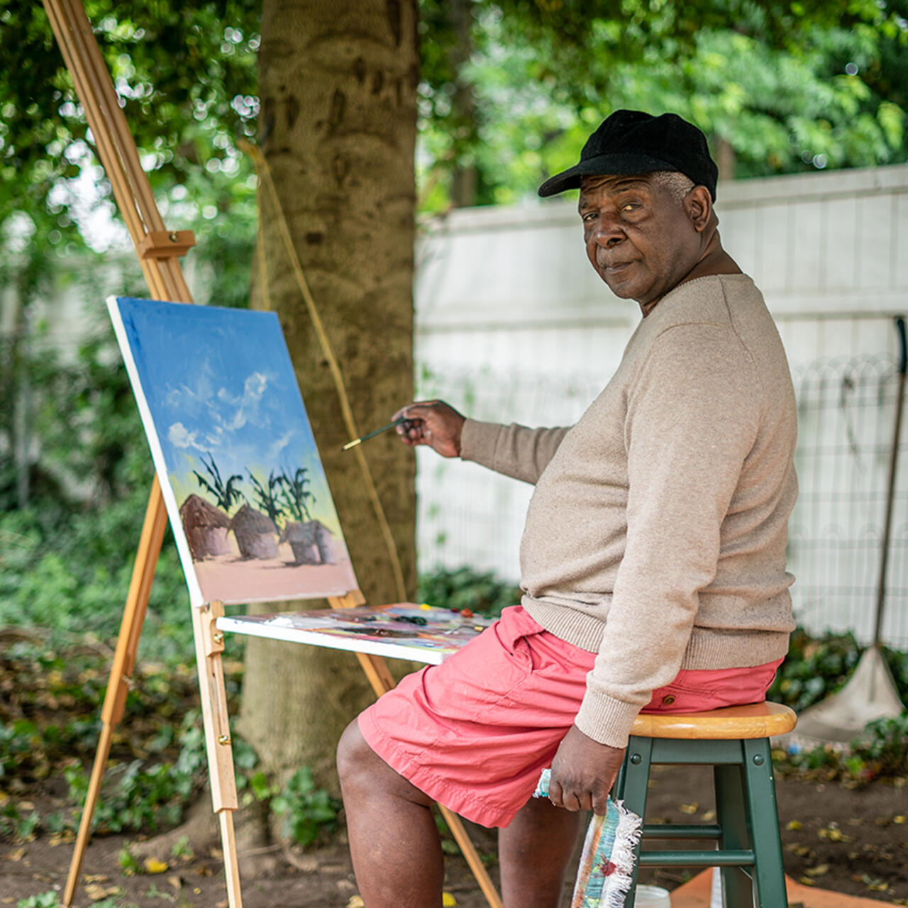 Chishimba painting outside.
