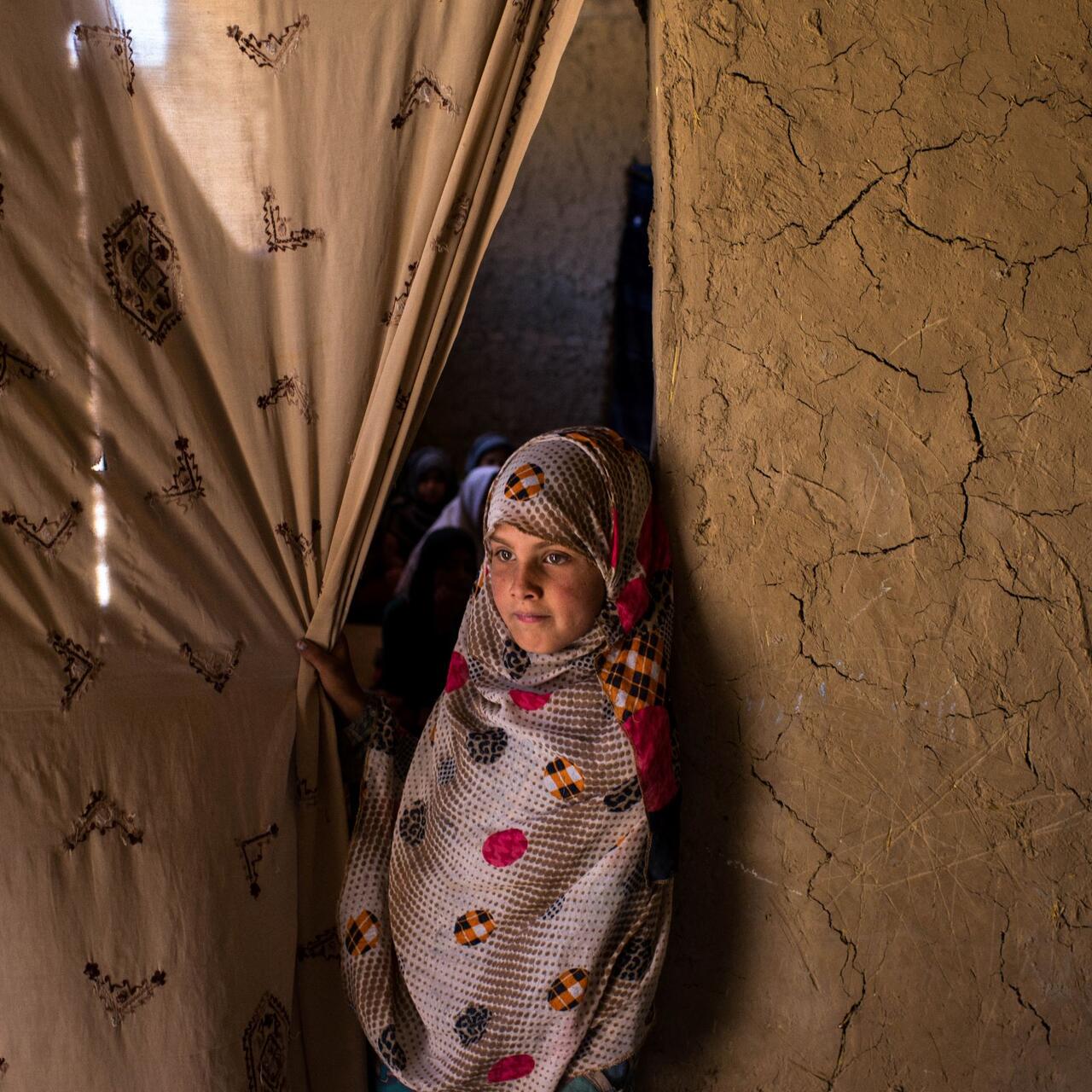 A young girl at the entrance to a classroom in eastern Kabul