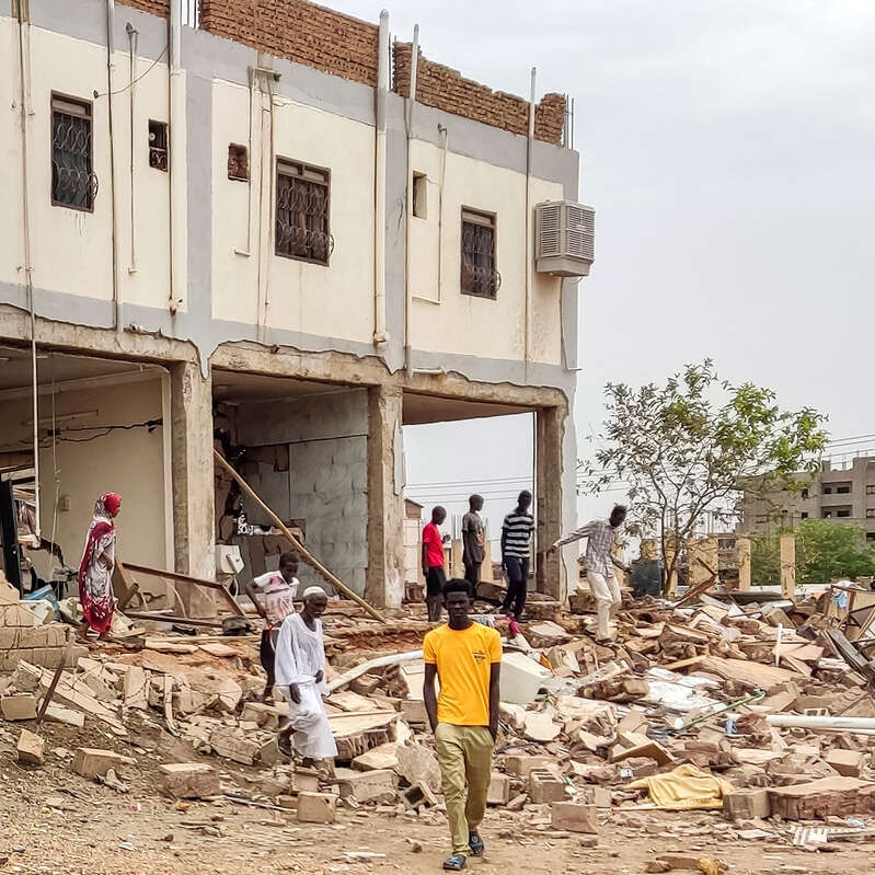 People inspect the war damage to a residential building in the Azhari district of Khartoum, Sudan.