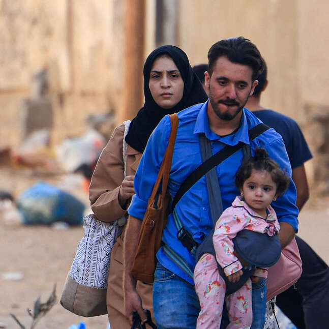 Palestinians flee their homes following Israeli airstrikes in Gaza City on October 13, 2023.