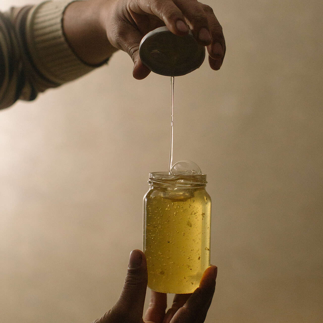Huthaifa holding a jar of honey