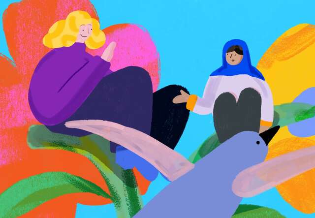 A teacher and student sit on a colourful flower