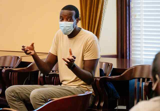 Interpreter sitting and translating language during cultural orientation class.