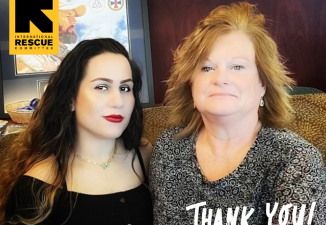 Two women sitting next to one another