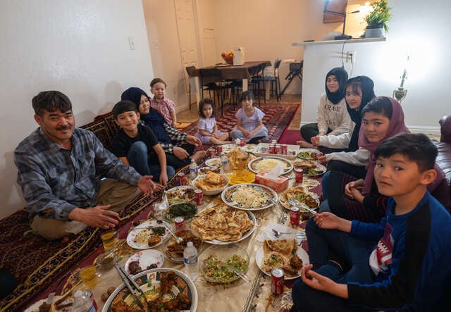 The family sit around their prepared Iftar meal.