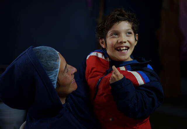 Sara holds her nine-year-old son, who has cerebral palsy, at a shelter in Ciudad Juárez.