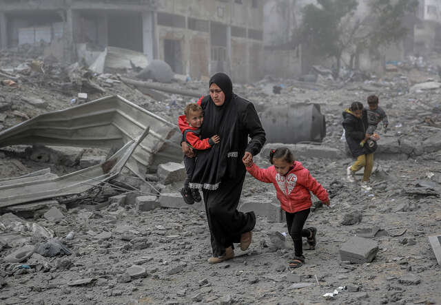 Palestinians flee the area after Israeli bombardment in central Gaza City.