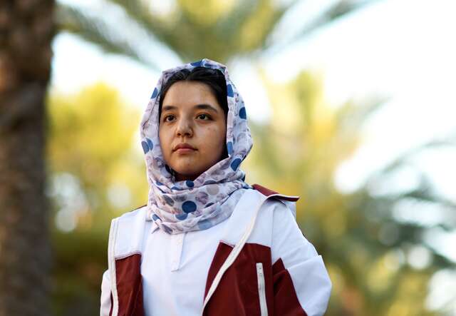 An Afghan woman poses for a photo at her new university in Arizona.