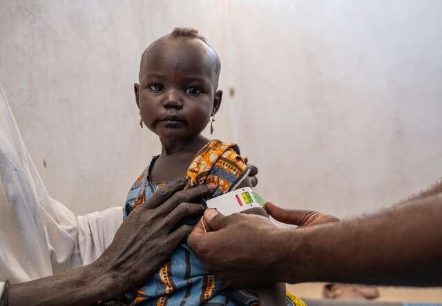A young child is screened for malnutrition by an IRC staff member in Chad.
