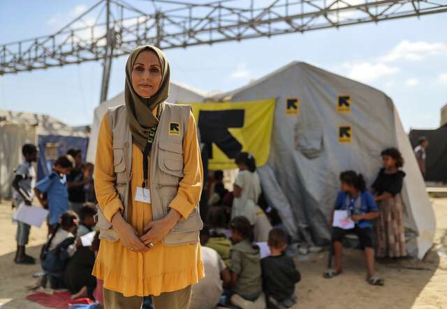 An IRC staff members stands outside of a mental health and psychosocial support program in Gaza.