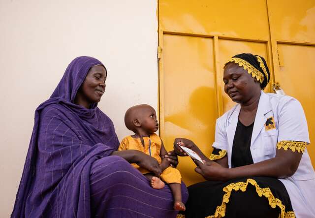 An IRC health care worker treats a young child for malnutrition in Chad.