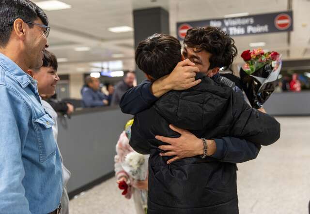 Wasiqullah hugs his little brother for the first time in years as he reunites with his family at the Dulles Airport in Virginia.
