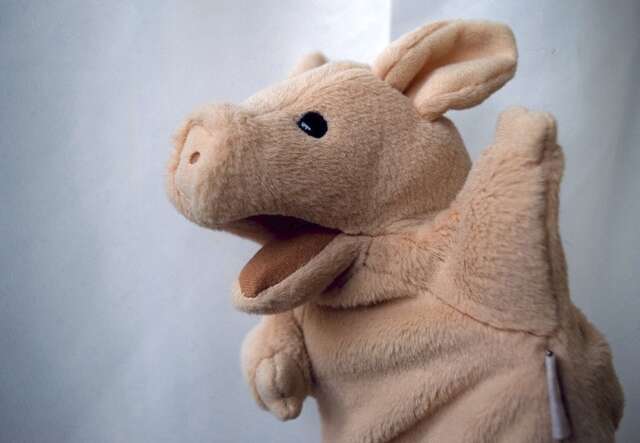A puppet that is a soft, pink pig