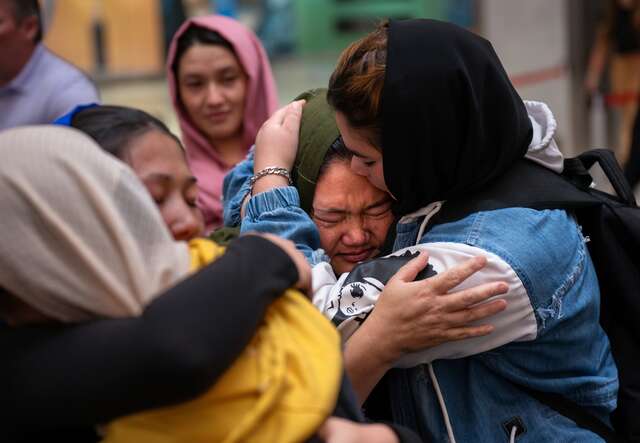 Two sisters embrace after they are reunited at an airport in the U.S.