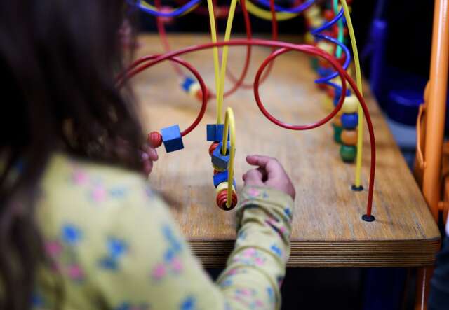 A child plays with a toy at the IRC's Welcome Center.