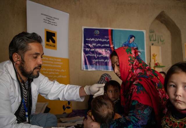 An IRC doctor treats a young girl at an IRC health center in Afghanistan.