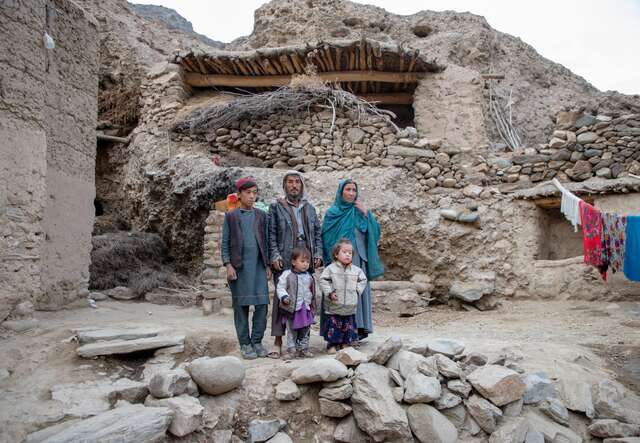 The Ali family poses for a photo in front of their home in rural Afghanistan.