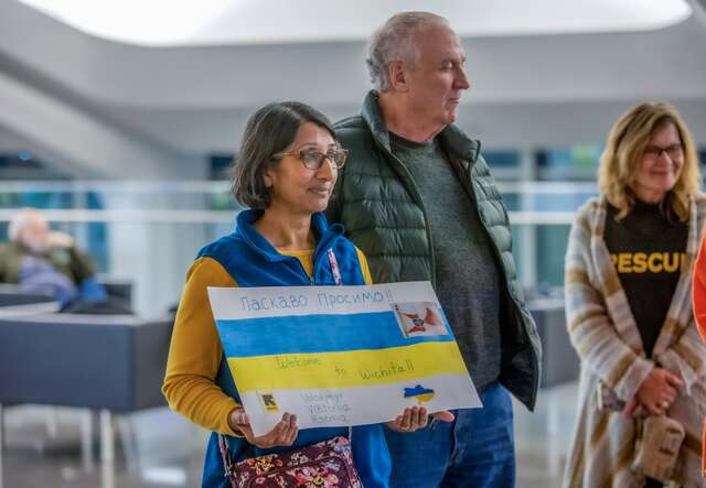 Two IRC supporters prepare to welcome Ukrainians arriving in the US.