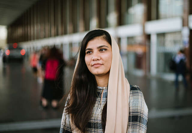 Maryam faces the camera, smiling.