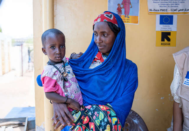 Zeinab’s mother looks at her with care