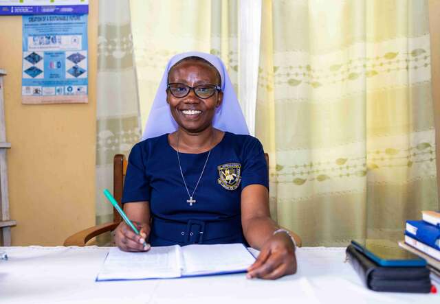 This image shows a teacher smiling to the camera