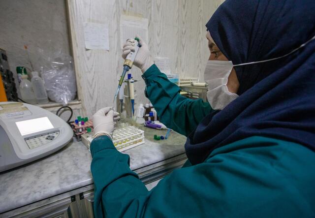 A lab technician analyses a blood test at Idlib Surgical Hospital.