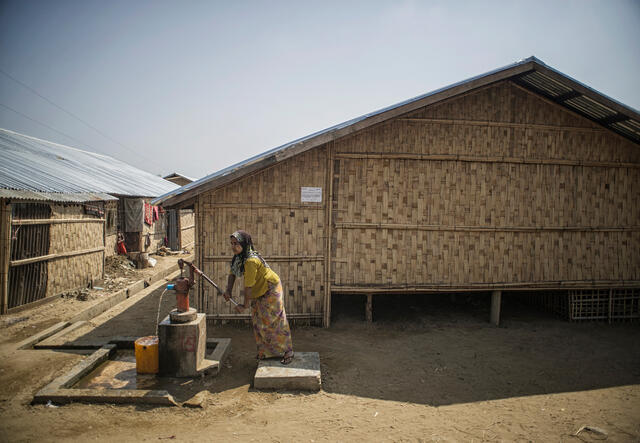 A woman pumps water in Myanmar.
