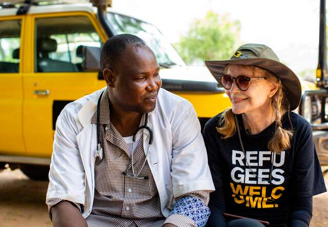 Mia Farrow sits talking with Bebnone Dominique, head of the Mangalme’ Health Center where the International Rescue Committee works in the Guera region of Chad