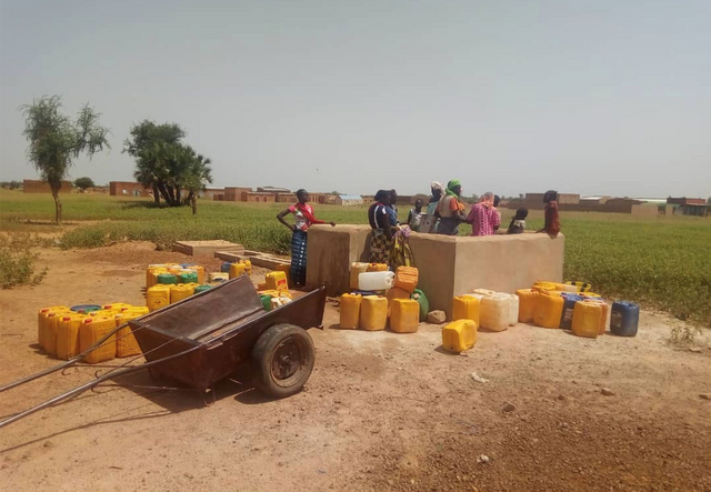 People gathered at an -supported water station near Djibo, in northern Burkina Faso.