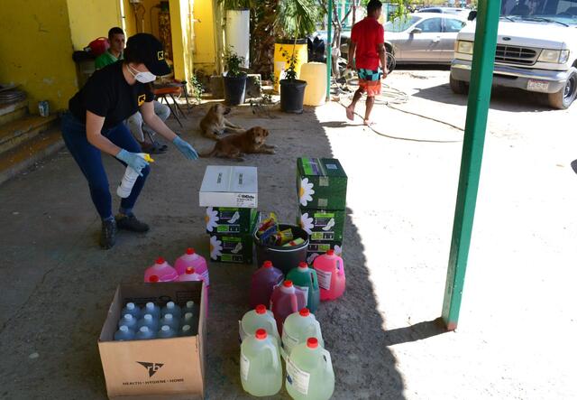 An IRC staff member stands above buckets of cleaning supplies to be delivered to shelters in Ciudad Juárez, Mexico.