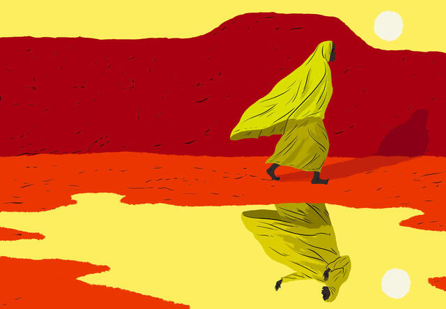 Marie, a woman who journeyed from Cameroon to Niger, walks next to a lake that shows her reflection. She is wearing a yellow head scarf and there is a red mountain behind her.