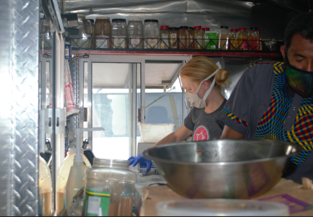 Abudu from Kafe Mamai cooking food.