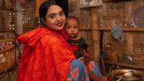 A woman and her child pose for a photo in Bangladesh.