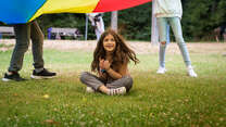 A girl participates at an IRC activity in a park in Germany.