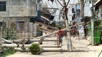 A man examines a downed power line caused by the earthquake in Myanmar.