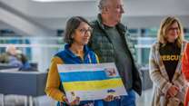 Two IRC supporters prepare to welcome Ukrainians arriving in the US.