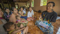 Daw Aye Than, a member of an IRC-organized “mother support group” shows various contraceptives in Yae Kyaw village.