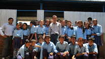 Secondary school principal Roshan Dhakal and some of his students outside a temporary learning centre.