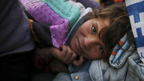 A Syrian refugee girl napping inside a tent in Greece