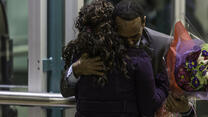 A father and daughter, Somali refugees, hug after being reunited at SeaTac airport